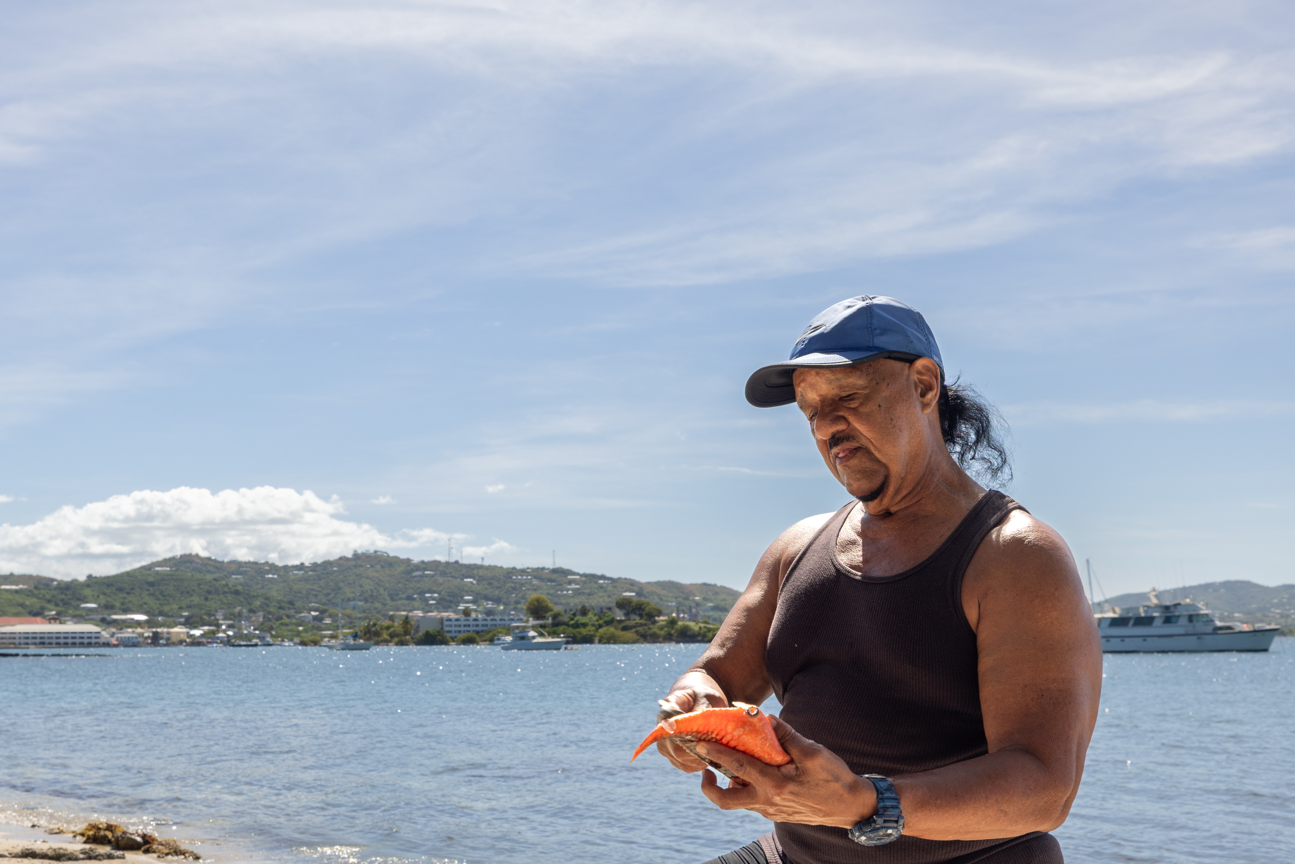 Olay Marin lives in a neighboring community near Altona Lagoon and often cleans his fish on the beach beside the lagoon.